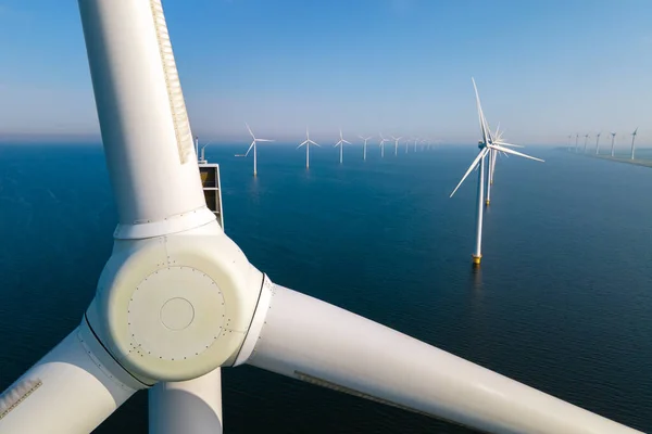 Huge windmill turbines, Offshore Windmill farm in the ocean Westermeerwind park , windmills isolated at sea on a beautiful bright day Netherlands Flevoland Noordoostpolder —  Fotos de Stock