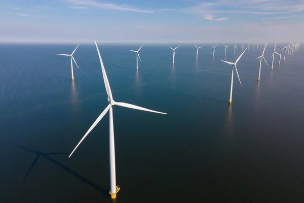 Huge windmill turbines, Offshore Windmill farm in the ocean Westermeerwind park , windmills isolated at sea on a beautiful bright day Netherlands Flevoland Noordoostpolder — ストック写真