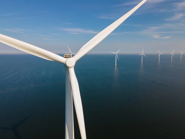 Huge windmill turbines, Offshore Windmill farm in the ocean Westermeerwind park , windmills isolated at sea on a beautiful bright day Netherlands Flevoland Noordoostpolder — Stok fotoğraf