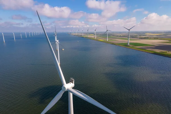 Huge windmill turbines, Offshore Windmill farm in the ocean Westermeerwind park , windmills isolated at sea on a beautiful bright day Netherlands Flevoland Noordoostpolder — Stock Photo, Image