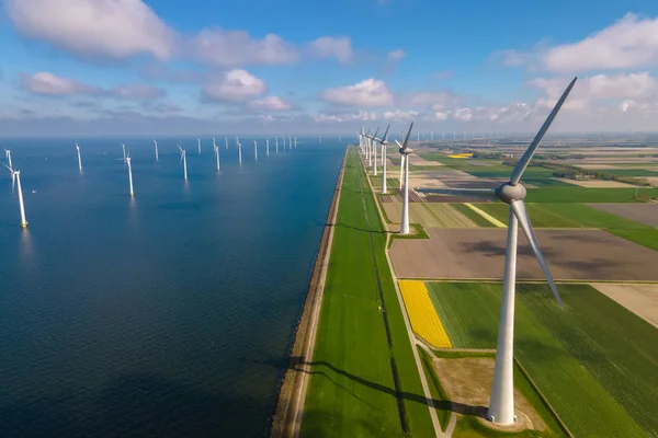 Huge windmill turbines, Offshore Windmill farm in the ocean Westermeerwind park , windmills isolated at sea on a beautiful bright day Netherlands Flevoland Noordoostpolder — стокове фото