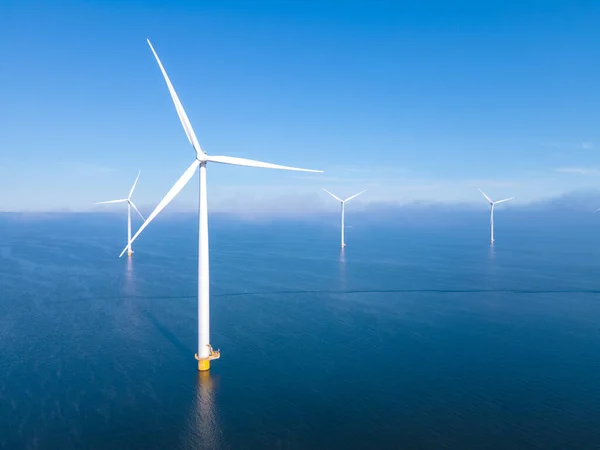 Huge windmill turbines, Offshore Windmill farm in the ocean Westermeerwind park , windmills isolated at sea on a beautiful bright day Netherlands Flevoland Noordoostpolder — Stock Photo, Image