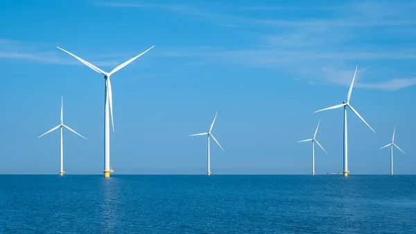 Huge windmill turbines, Offshore Windmill farm in the ocean Westermeerwind park , windmills isolated at sea on a beautiful bright day Netherlands Flevoland Noordoostpolder — Stock fotografie