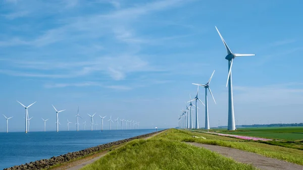 Huge windmill turbines, Offshore Windmill farm in the ocean Westermeerwind park , windmills isolated at sea on a beautiful bright day Netherlands Flevoland Noordoostpolder — 스톡 사진