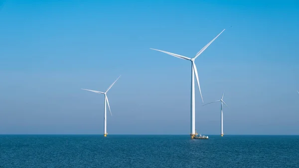 Huge windmill turbines, Offshore Windmill farm in the ocean Westermeerwind park , windmills isolated at sea on a beautiful bright day Netherlands Flevoland Noordoostpolder — Stockfoto