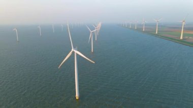 Huge windmill turbines, Offshore Windmill farm in the ocean Westermeerwind park , windmills isolated at sea on a beautiful bright day Netherlands Flevoland Noordoostpolder