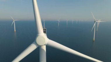 Huge windmill turbines, Offshore Windmill farm in the ocean Westermeerwind park , windmills isolated at sea on a beautiful bright day Netherlands Flevoland Noordoostpolder