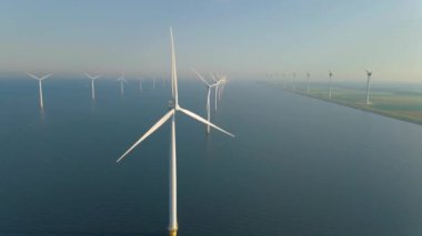 Huge windmill turbines, Offshore Windmill farm in the ocean Westermeerwind park , windmills isolated at sea on a beautiful bright day Netherlands Flevoland Noordoostpolder