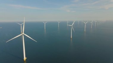 Huge windmill turbines, Offshore Windmill farm in the ocean Westermeerwind park , windmills isolated at sea on a beautiful bright day Netherlands Flevoland Noordoostpolder
