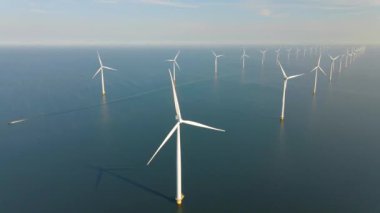 Huge windmill turbines, Offshore Windmill farm in the ocean Westermeerwind park , windmills isolated at sea on a beautiful bright day Netherlands Flevoland Noordoostpolder