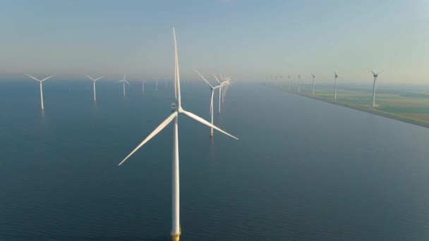 Huge windmill turbines, Offshore Windmill farm in the ocean Westermeerwind park , windmills isolated at sea on a beautiful bright day Netherlands Flevoland Noordoostpolder — Vídeo de Stock