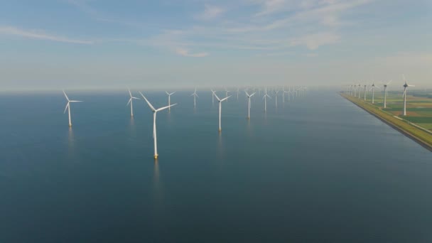 Huge windmill turbines, Offshore Windmill farm in the ocean Westermeerwind park , windmills isolated at sea on a beautiful bright day Netherlands Flevoland Noordoostpolder — Stok video