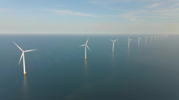 Huge windmill turbines, Offshore Windmill farm in the ocean Westermeerwind park , windmills isolated at sea on a beautiful bright day Netherlands Flevoland Noordoostpolder — Vídeo de stock