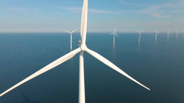 Huge windmill turbines, Offshore Windmill farm in the ocean Westermeerwind park , windmills isolated at sea on a beautiful bright day Netherlands Flevoland Noordoostpolder — Vídeo de Stock