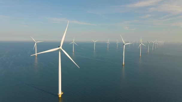 Huge windmill turbines, Offshore Windmill farm in the ocean Westermeerwind park , windmills isolated at sea on a beautiful bright day Netherlands Flevoland Noordoostpolder — стокове відео