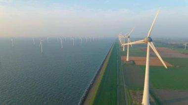 Huge windmill turbines, Offshore Windmill farm in the ocean Westermeerwind park , windmills isolated at sea on a beautiful bright day Netherlands Flevoland Noordoostpolder