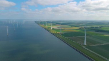 Huge windmill turbines, Offshore Windmill farm in the ocean Westermeerwind park , windmills isolated at sea on a beautiful bright day Netherlands Flevoland Noordoostpolder