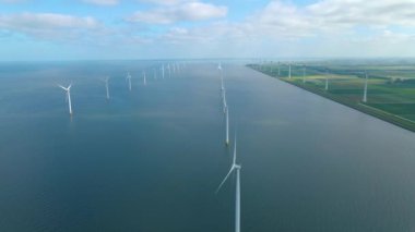 Huge windmill turbines, Offshore Windmill farm in the ocean Westermeerwind park , windmills isolated at sea on a beautiful bright day Netherlands Flevoland Noordoostpolder