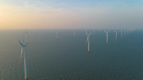 Huge windmill turbines, Offshore Windmill farm in the ocean Westermeerwind park , windmills isolated at sea on a beautiful bright day Netherlands Flevoland Noordoostpolder — Vídeo de Stock