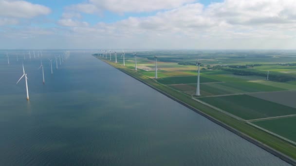 Huge windmill turbines, Offshore Windmill farm in the ocean Westermeerwind park , windmills isolated at sea on a beautiful bright day Netherlands Flevoland Noordoostpolder — Vídeo de Stock