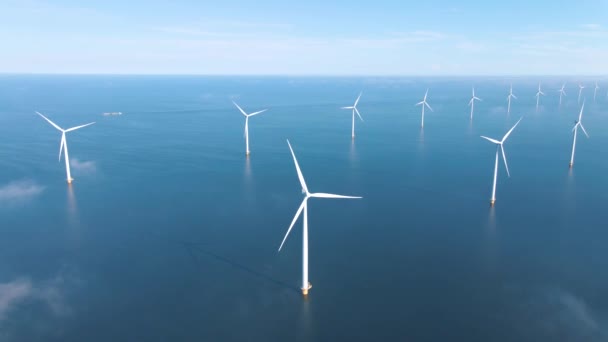 Huge windmill turbines, Offshore Windmill farm in the ocean Westermeerwind park , windmills isolated at sea on a beautiful bright day Netherlands Flevoland Noordoostpolder — Stockvideo
