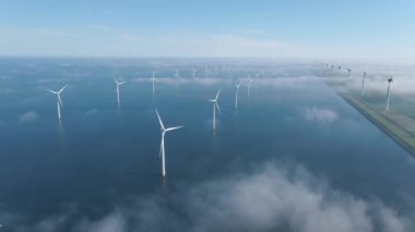 Huge windmill turbines, Offshore Windmill farm in the ocean Westermeerwind park , windmills isolated at sea on a beautiful bright day Netherlands Flevoland Noordoostpolder