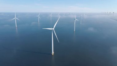 Huge windmill turbines, Offshore Windmill farm in the ocean Westermeerwind park , windmills isolated at sea on a beautiful bright day Netherlands Flevoland Noordoostpolder