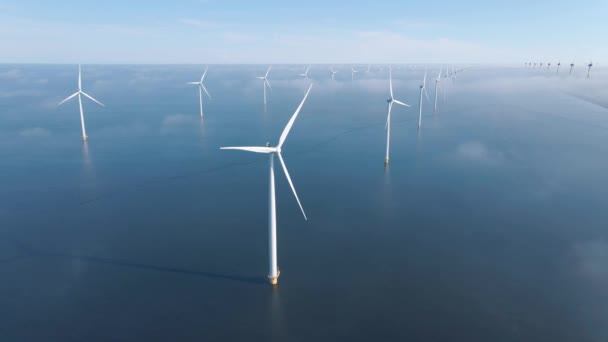 Huge windmill turbines, Offshore Windmill farm in the ocean Westermeerwind park , windmills isolated at sea on a beautiful bright day Netherlands Flevoland Noordoostpolder — Stok video