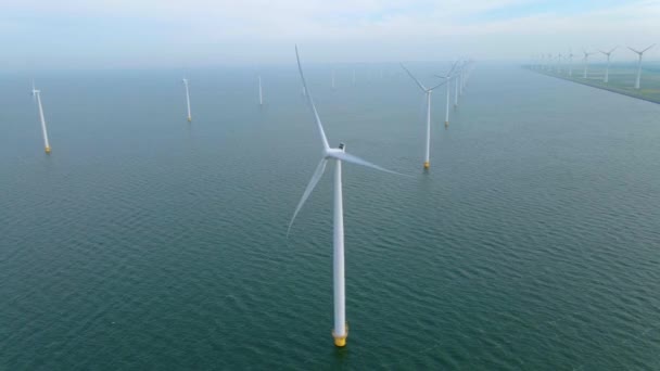 Huge windmill turbines, Offshore Windmill farm in the ocean Westermeerwind park , windmills isolated at sea on a beautiful bright day Netherlands Flevoland Noordoostpolder — Stock Video