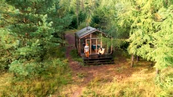 Wooden hut in autumn forest in the Netherlands, cabin off grid ,wooden cabin circled by colorful yellow and red fall trees — Stock Video