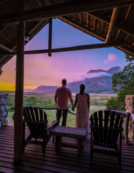 Couple man and woman mid age in front of their lodge during vacation in South Africa, Mountains and grassland near Hermanus at the garden route Western Cape South Africa Whale coast — Fotografia de Stock