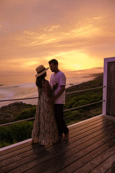 couple man and woman watching sunset at De Hoop Nature reserve South Africa Western Cape, beautiful beach of south africa white dunes at the de hoop nature reserve which is part of the garden route
