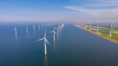 Huge windmill turbines, Offshore Windmill farm in the ocean Westermeerwind park , windmills isolated at sea on a beautiful bright day Netherlands Flevoland Noordoostpolder