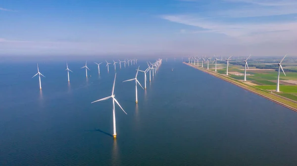 Huge windmill turbines, Offshore Windmill farm in the ocean Westermeerwind park , windmills isolated at sea on a beautiful bright day Netherlands Flevoland Noordoostpolder — Zdjęcie stockowe