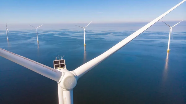 Huge windmill turbines, Offshore Windmill farm in the ocean Westermeerwind park , windmills isolated at sea on a beautiful bright day Netherlands Flevoland Noordoostpolder — Stok fotoğraf