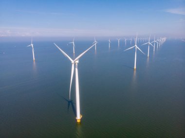 Huge windmill turbines, Offshore Windmill farm in the ocean Westermeerwind park , windmills isolated at sea on a beautiful bright day Netherlands Flevoland Noordoostpolder