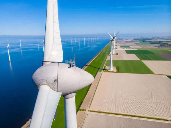 Huge windmill turbines, Offshore Windmill farm in the ocean Westermeerwind park , windmills isolated at sea on a beautiful bright day Netherlands Flevoland Noordoostpolder — Fotografia de Stock