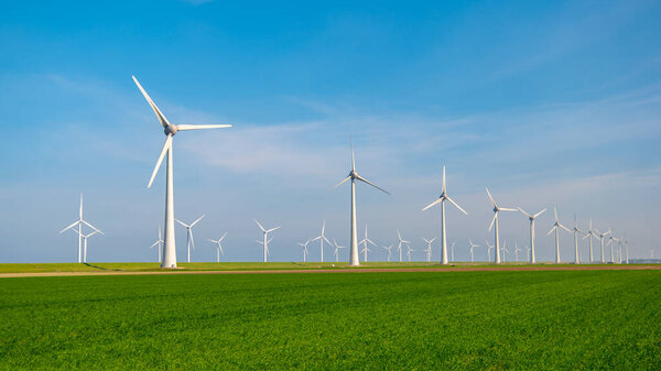 Huge windmill turbines, Offshore Windmill farm in the ocean Westermeerwind park , windmills isolated at sea on a beautiful bright day Netherlands Flevoland Noordoostpolder