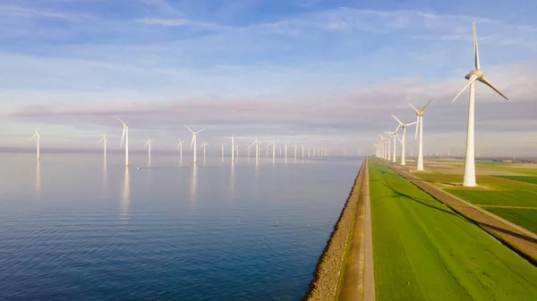 Huge windmill turbines, Offshore Windmill farm in the ocean Westermeerwind park , windmills isolated at sea on a beautiful bright day Netherlands Flevoland Noordoostpolder — Zdjęcie stockowe