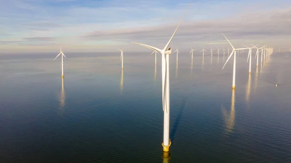 Huge windmill turbines, Offshore Windmill farm in the ocean Westermeerwind park , windmills isolated at sea on a beautiful bright day Netherlands Flevoland Noordoostpolder — ストック写真