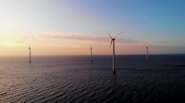 Okyanustaki yel değirmeni parkı, yeşil enerji üreten yel değirmeni türbinlerinin insansız hava görüntüsü, Hollanda 'da denizde izole edilmiş yel değirmenleri.
