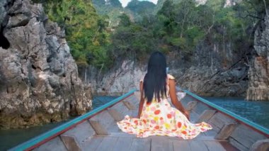 Khao Sok Thailand, woman on vacation in Thailand, girl in longtail boat at the Khao Sok national park Thailand