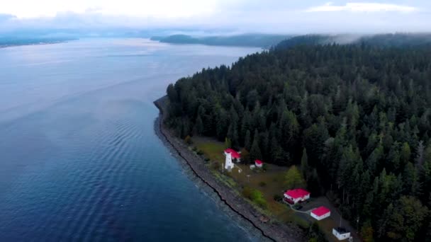 Vancouver Island, Kanada, Quadra Island starý historický maják na Cape Mudge pár ve žlutém plášti deště během bouře u pobřeží — Stock video