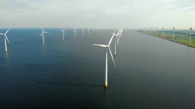 Okyanustaki yel değirmeni parkı, yeşil enerji üreten yel değirmeni türbinlerinin insansız hava görüntüsü, Hollanda 'da denizde izole edilmiş yel değirmenleri.