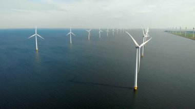 Okyanustaki yel değirmeni parkı, yeşil enerji üreten yel değirmeni türbinlerinin insansız hava görüntüsü, Hollanda 'da denizde izole edilmiş yel değirmenleri.