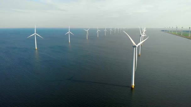 Windmill park in the ocean, drone aerial view of windmill turbines generating green energy electric, windmills isolated at sea in the Netherlands — Stock Video