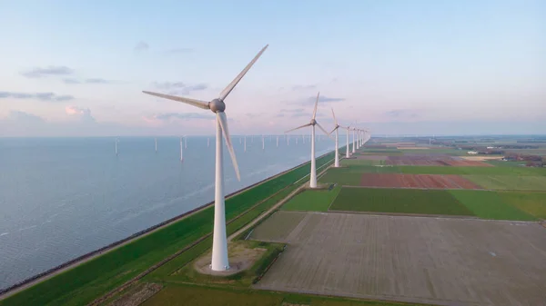 Windmill park in the ocean, drone aerial view of windmill turbines generating green energy electric, windmills isolated at sea in the Netherlands — Stock Photo, Image