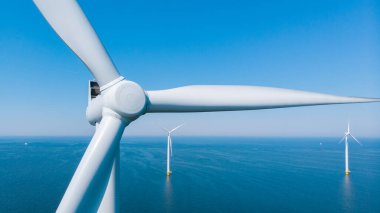 Okyanustaki yel değirmeni parkı, yeşil enerji üreten yel değirmeni türbinlerinin insansız hava görüntüsü Hollanda 'da denizde izole edilmiş yel değirmenleri. Yüksek kalite 4k görüntü