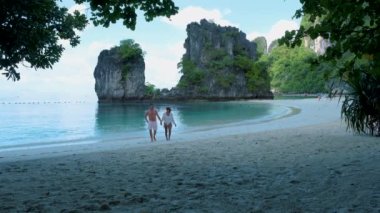 Koh Hong Adası Krabi Tayland plajındaki birkaç erkek ve kadın, Tayland 'da tropik bir plajdaki Asyalı kadın ve Avrupalı erkekler.. 
