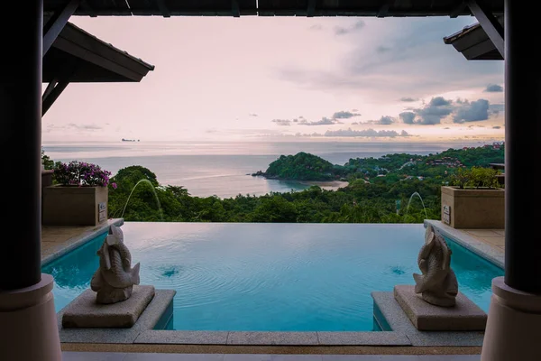 luxury vacation in Thailand pool of a luxury pool villa, swimming pool during vacation at the tropical islands Infinity pool during sunset